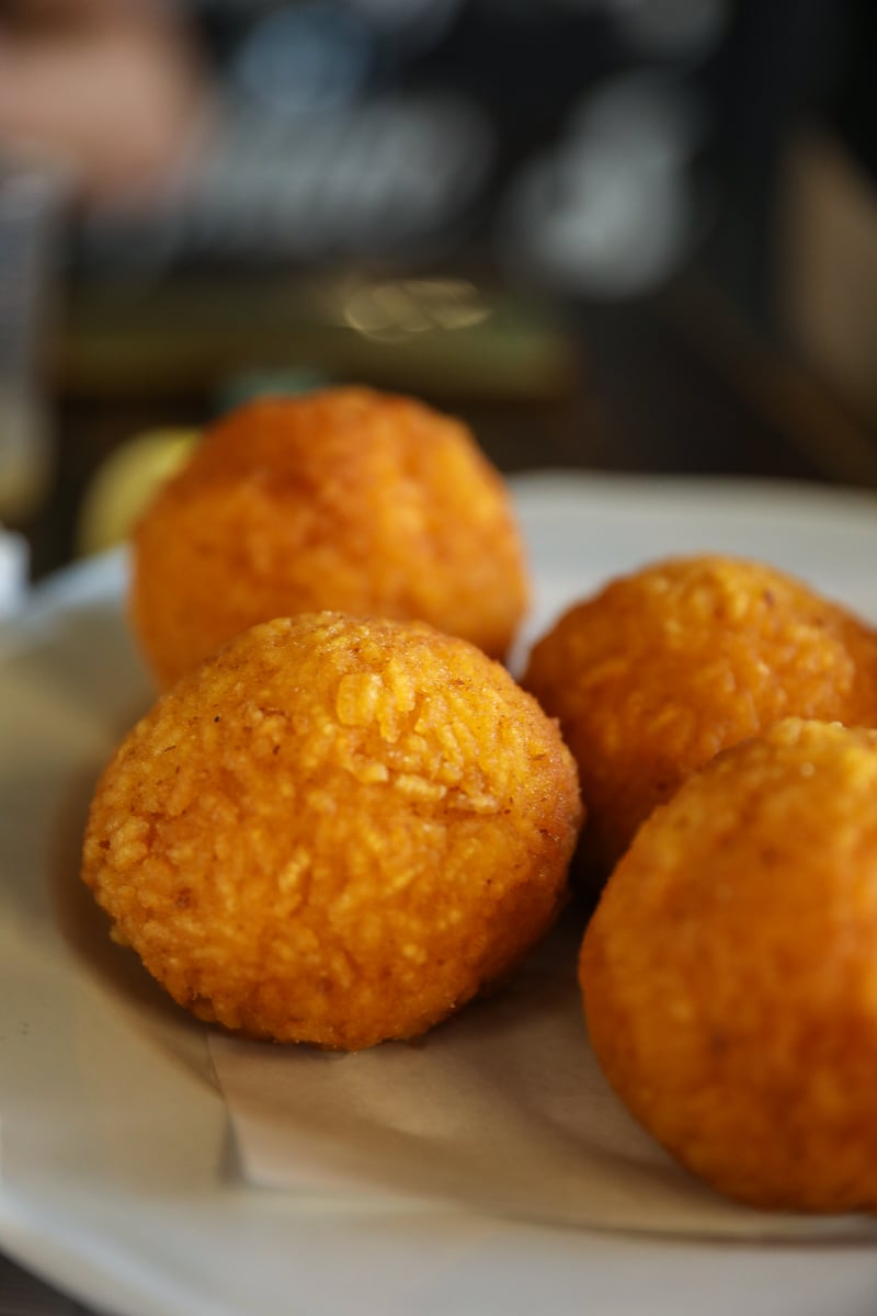 Close-up of golden arancine rice balls, classic Palermo street food in Sicily