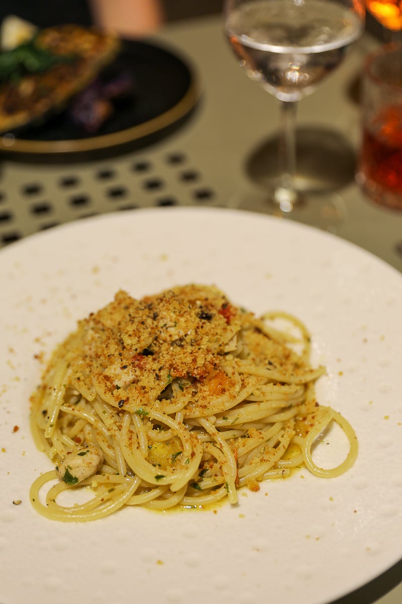 Plate of seafood pasta with breadcrumbs served at Quattro Mani restaurant