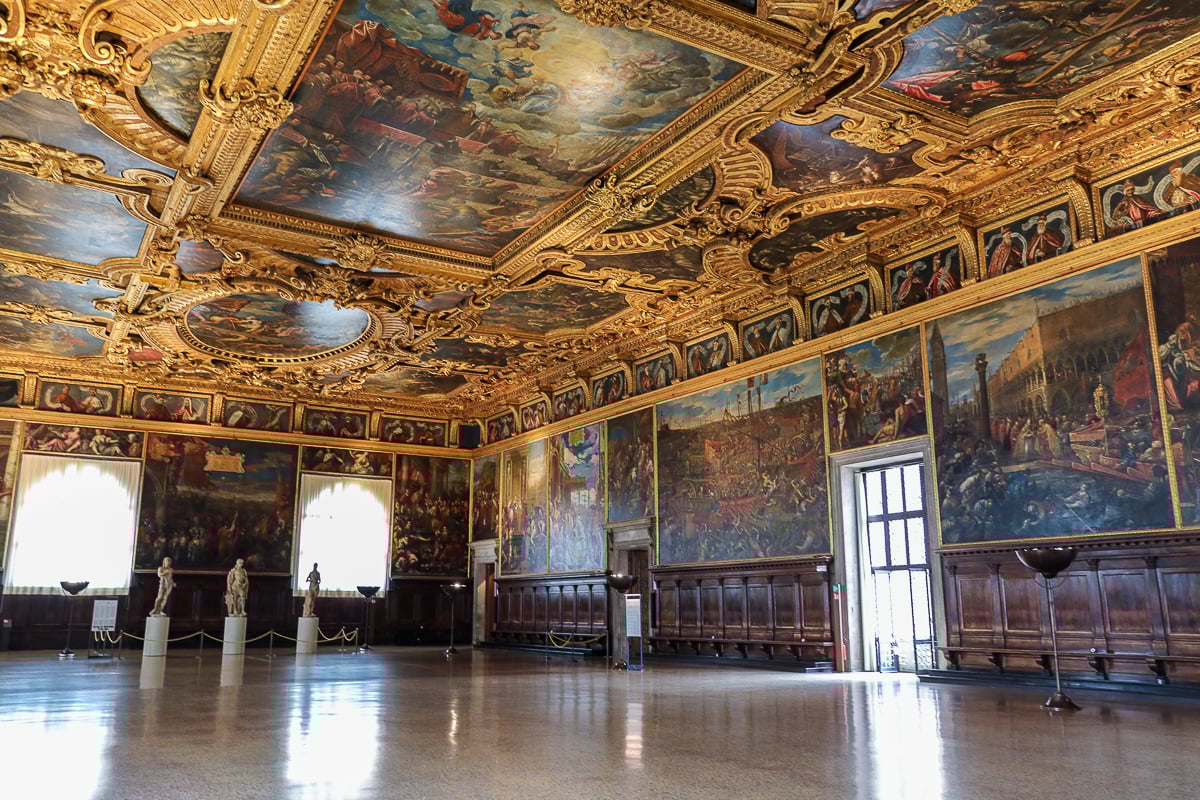 Empty grand hall inside Doge’s Palace with gilded ceiling paintings during early access, Venice