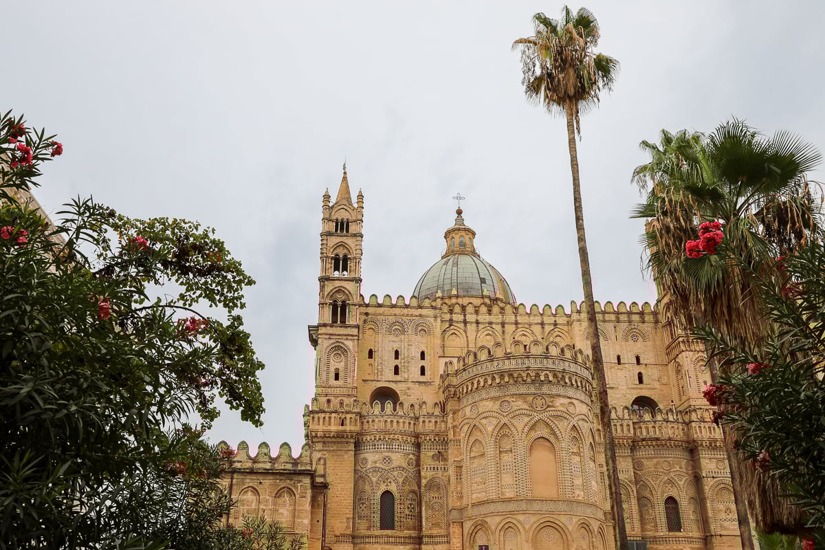 Palermo Cathedral façade and apse with Norman-Arab-Byzantine details and a tall palm tree in Sicily