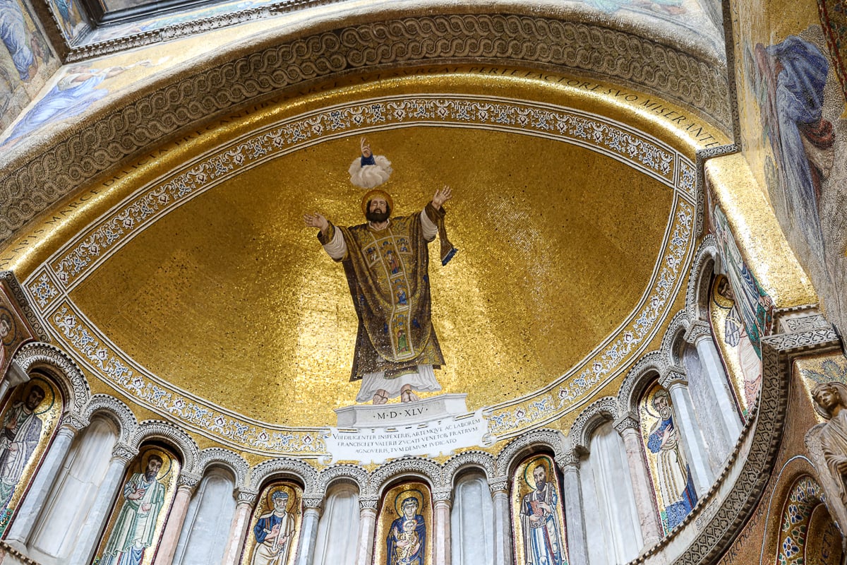 Glowing apse mosaic inside St. Mark’s Basilica – gold backdrop and saint figure, Venice