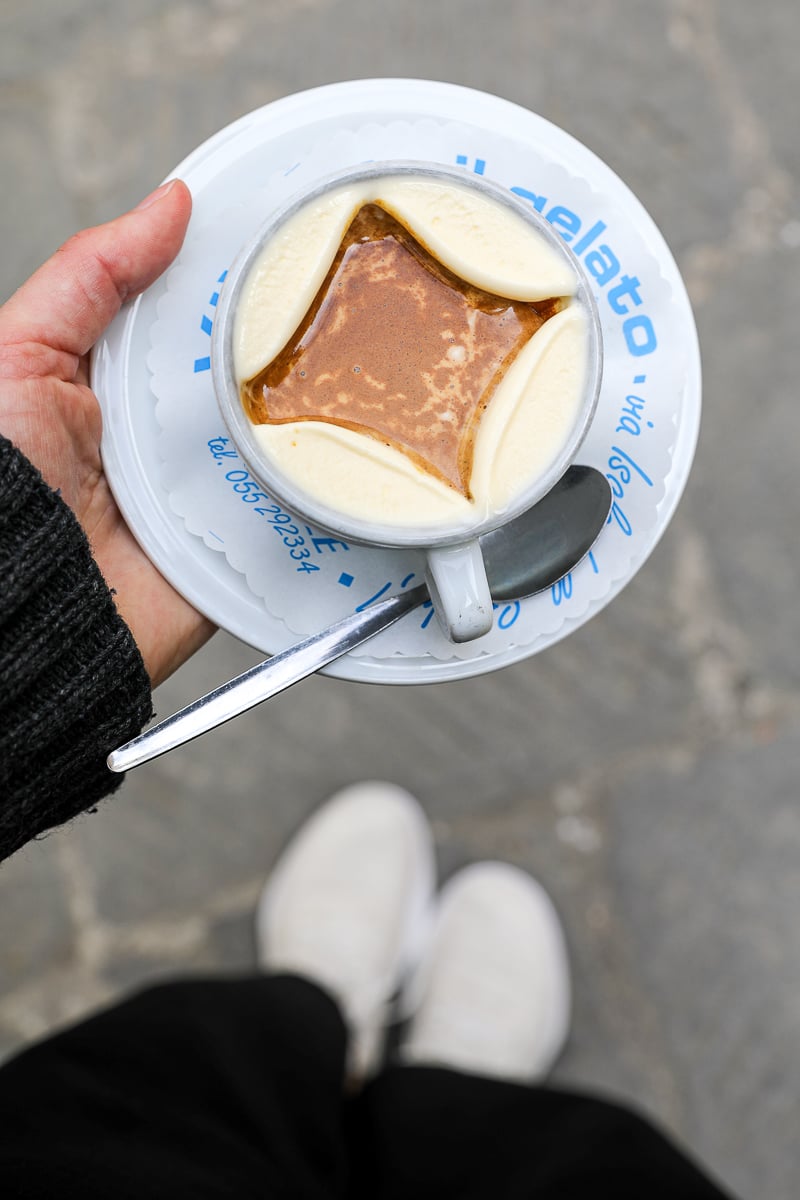 Overhead view of an affogato with vanilla gelato and hot espresso poured over the top, held outside a gelateria in Florence.