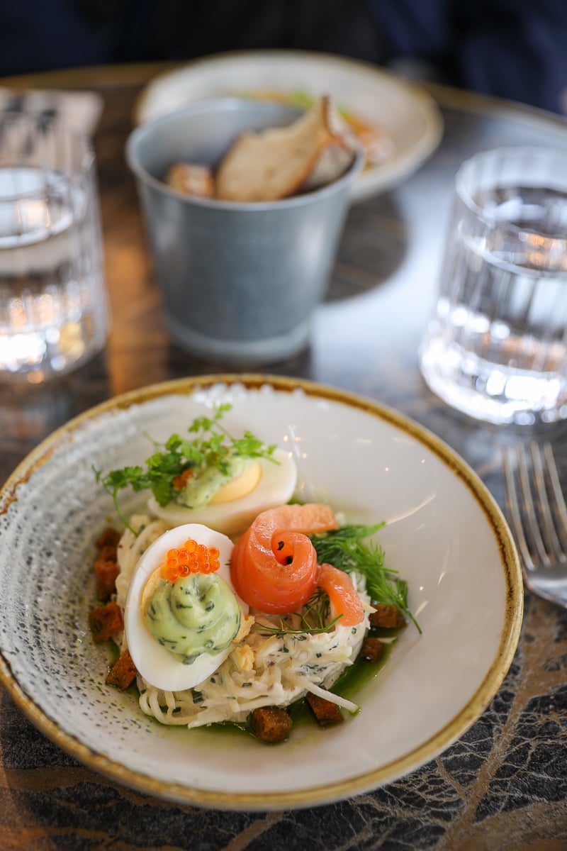 Elegantly plated smoked salmon starter with boiled egg and salmon roe at Bonbonne restaurant in Bayeux