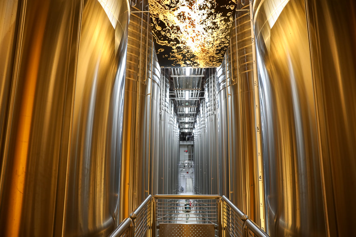 Towering stainless steel tanks at a large Champagne producer, seen on a Champagne day trip from Paris