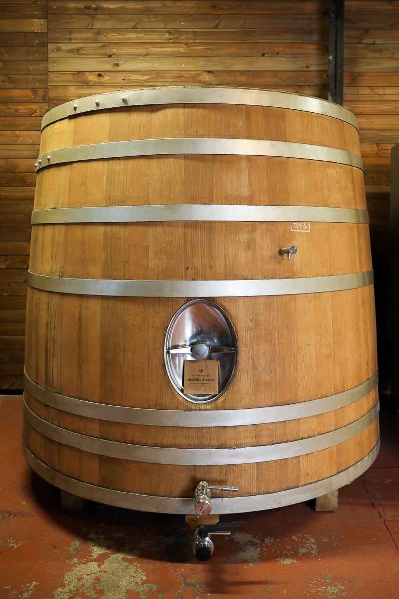 Large oak fermentation vat labeled Champagne Michel Fagot in the winery