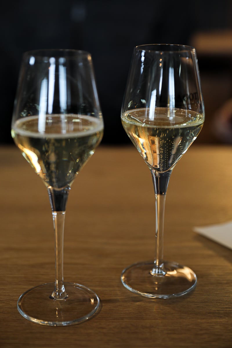 Two glasses of Champagne on a wooden table during a tasting at Michel Fagot