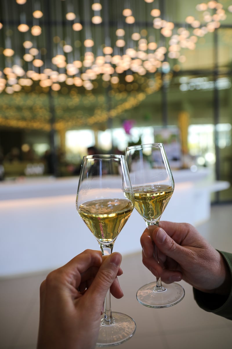 Toasting glasses of Champagne in the tasting room at a Champagne house