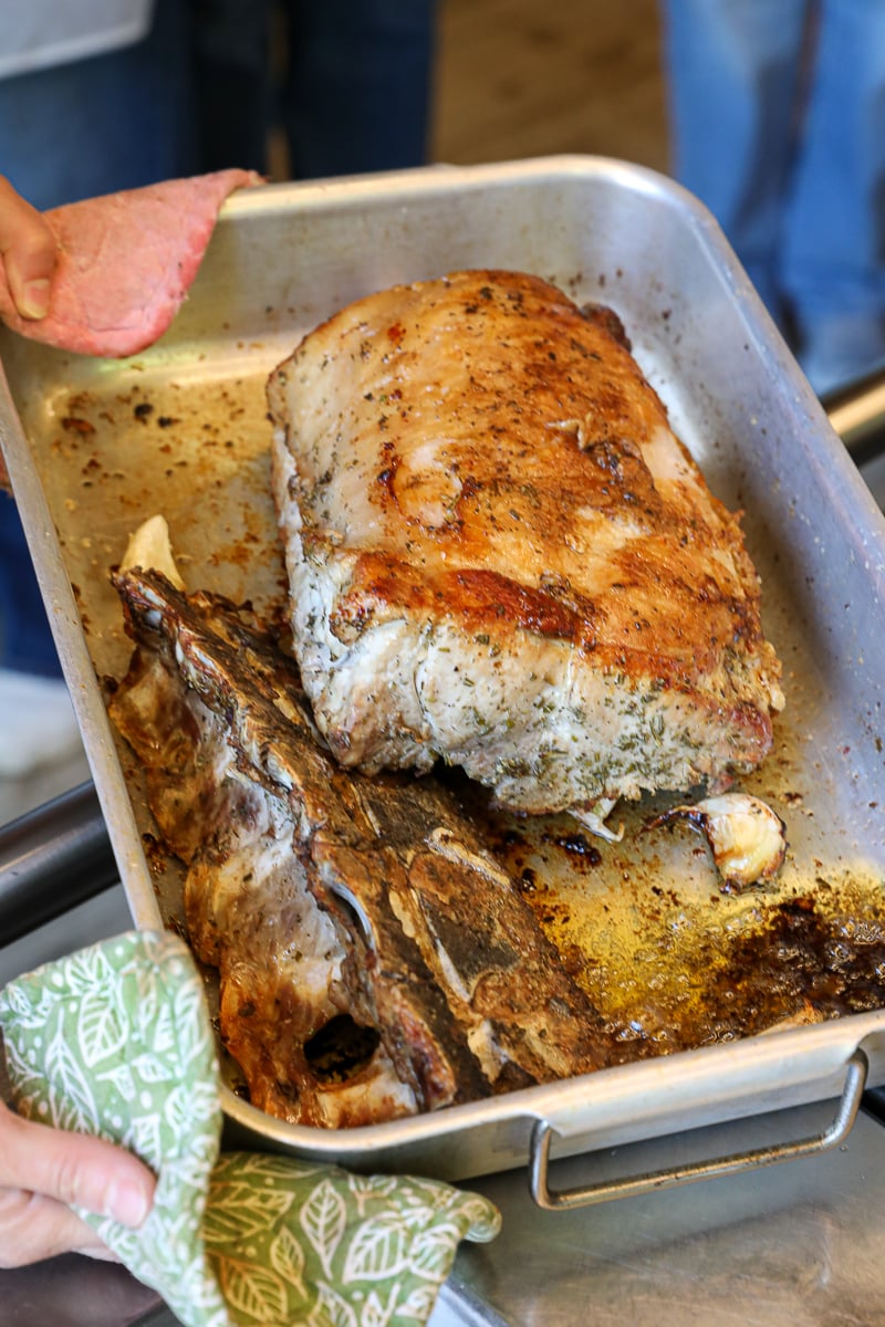 Roasted Tuscan pork with crispy skin and herbs fresh out of the oven during a farmhouse cooking class near Florence.