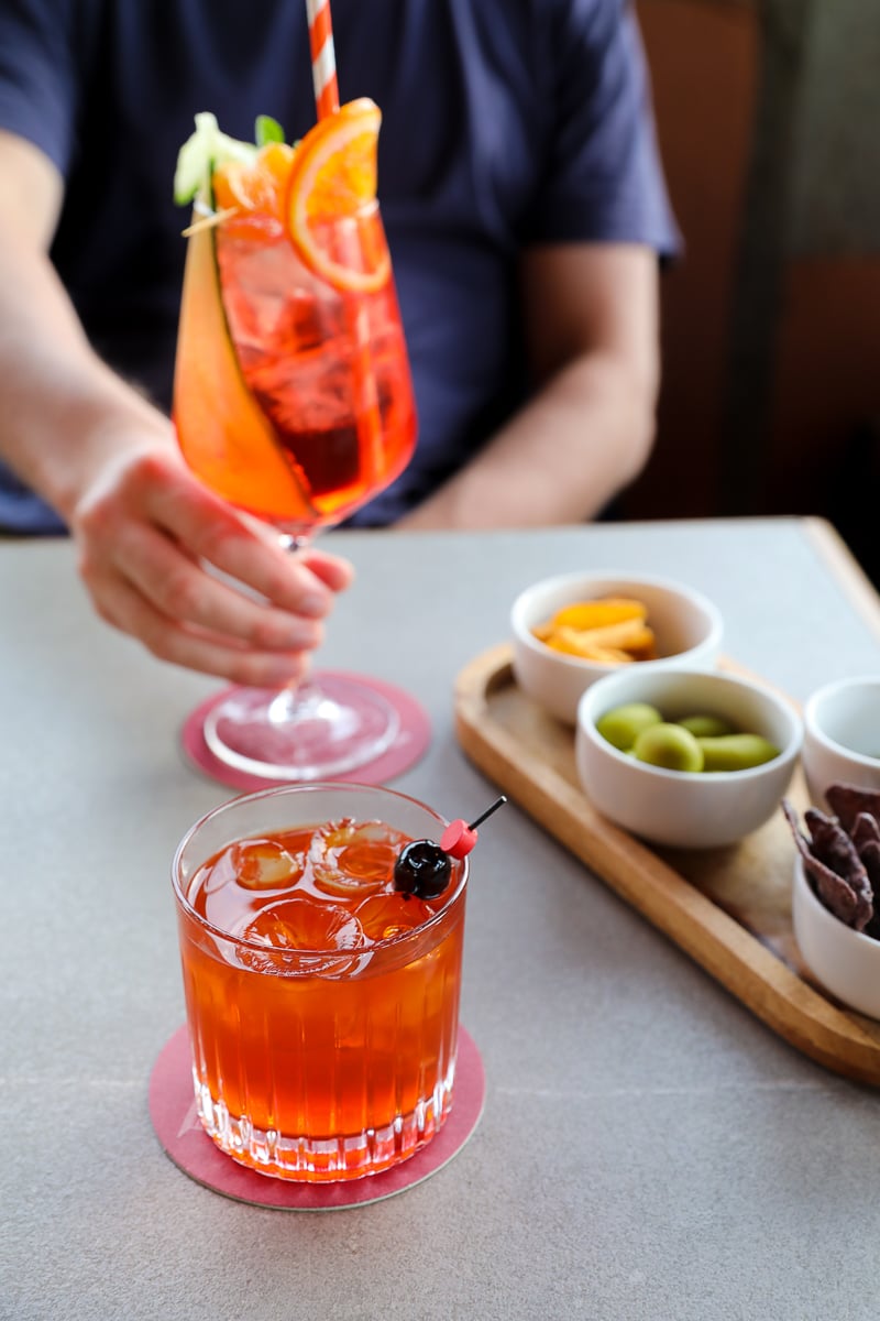 Aperol spritz and a Florentine whisky cocktail served on a table at Loggia Roof Bar in Florence.