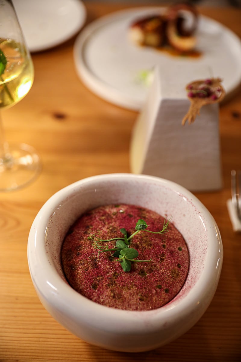 Fine-dining food served in a stone bowl at Nugolo, a modern restaurant in Florence.