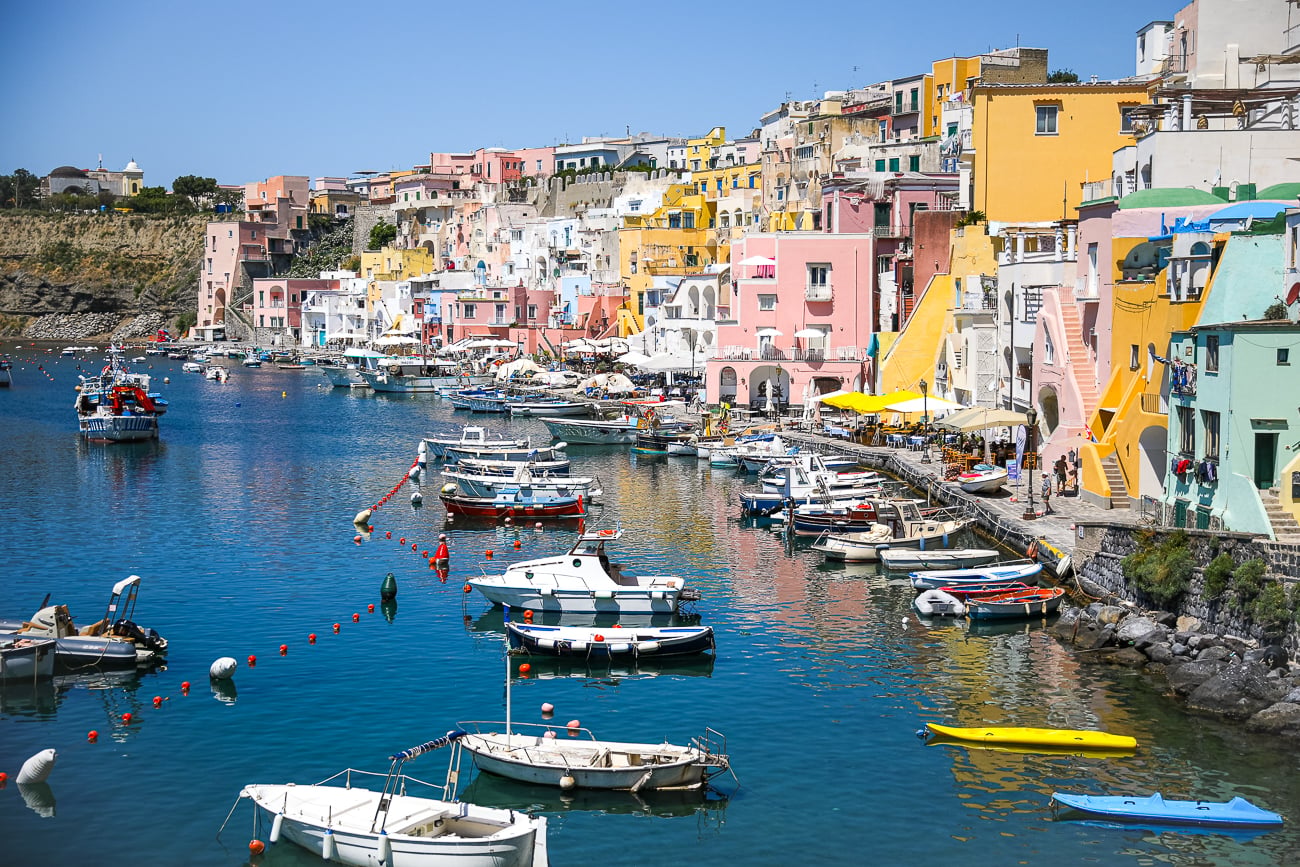 Colorful fishing boats and pastel waterfront houses at Marina Corricella, a must-see in Procida