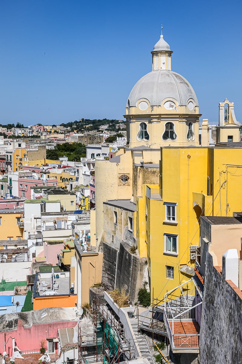 Domed bell tower of Santa Maria delle Grazie rising above the colorful houses of Marina Corricella