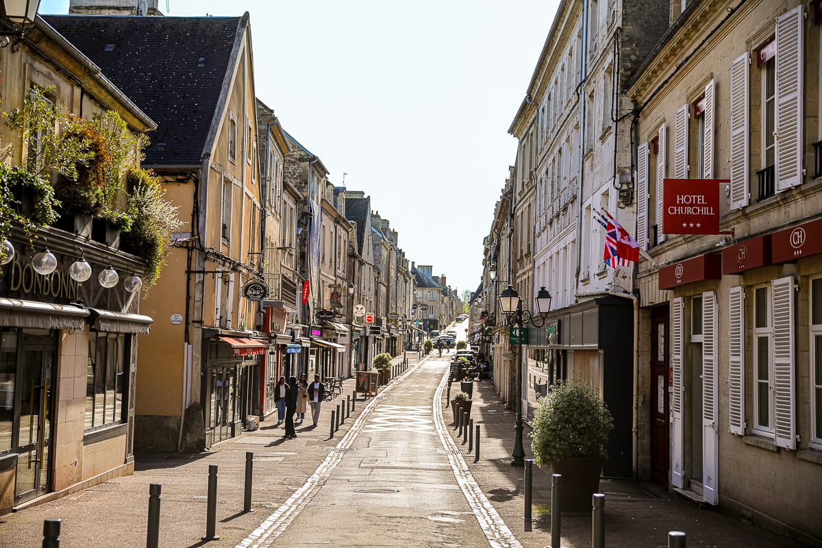 Sunny Rue Saint-Jean with the Hotel Churchill and restaurant Bonbonne visible
