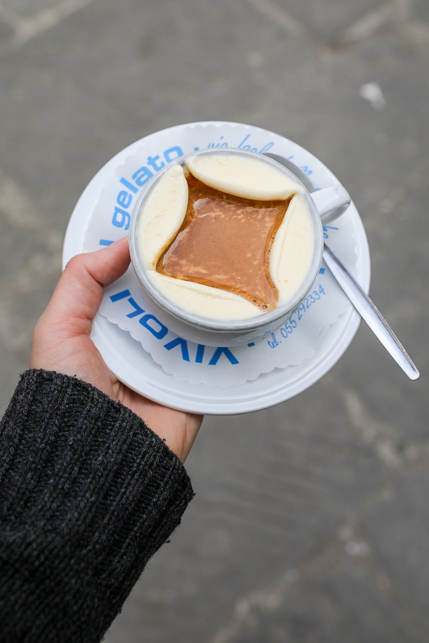 Overhead view of an affogato with vanilla gelato and hot espresso poured over the top, held outside Vivoli gelateria.