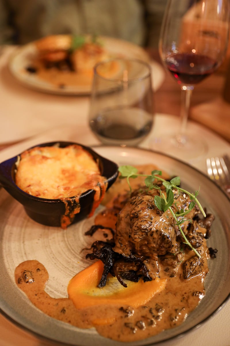 Beef filet with creamy sauce, vegetables, and cheesy potato gratin at La Table de Guigone