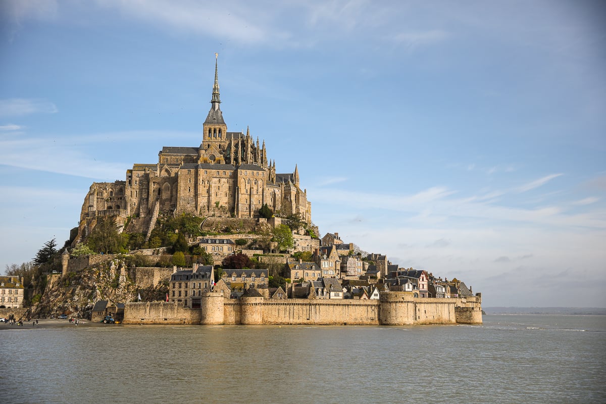 The majestic island abbey of Mont Saint-Michel rises from the surrounding water, a dramatic landmark that makes for an unforgettable day trip from Paris.