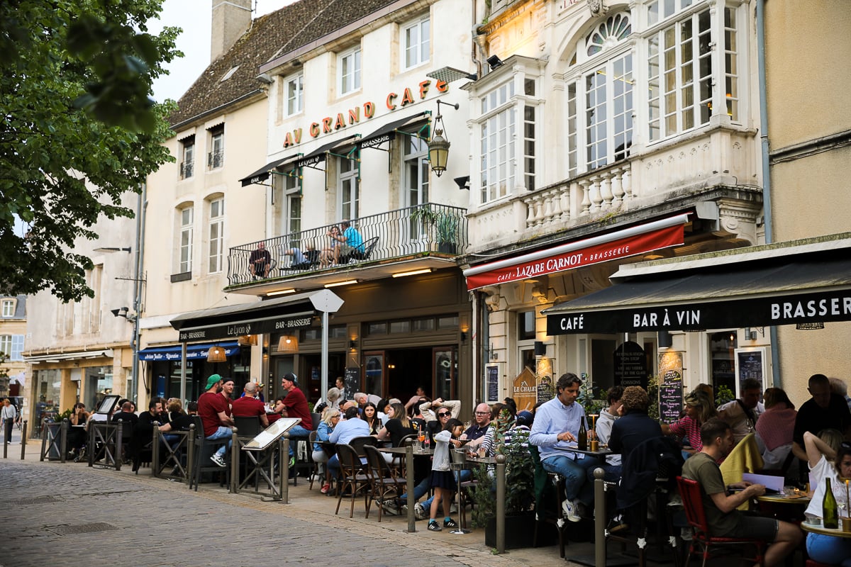 Busy outdoor cafés and wine bars in the historic center of Beaune, Burgundy