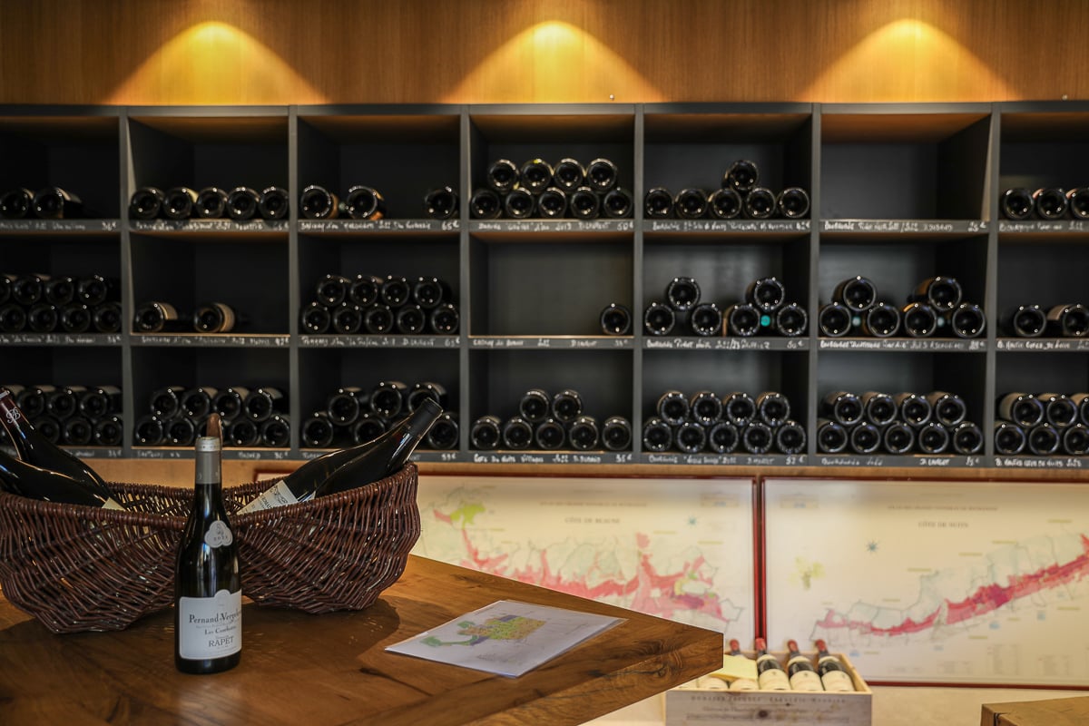 Burgundy wine shop with shelves of local bottles and Côte d’Or vineyard maps