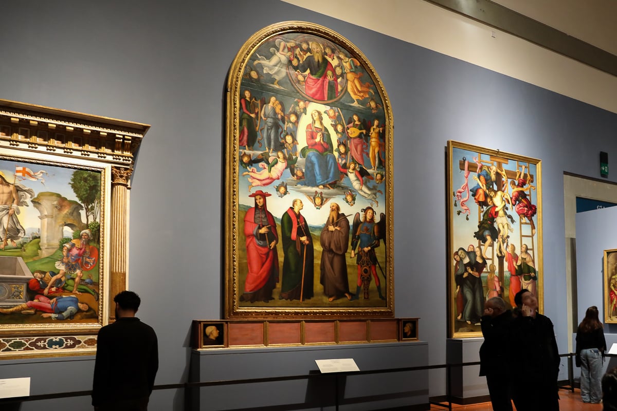 Medieval and Renaissance paintings displayed in an exhibition gallery at the Accademia Gallery in Florence.