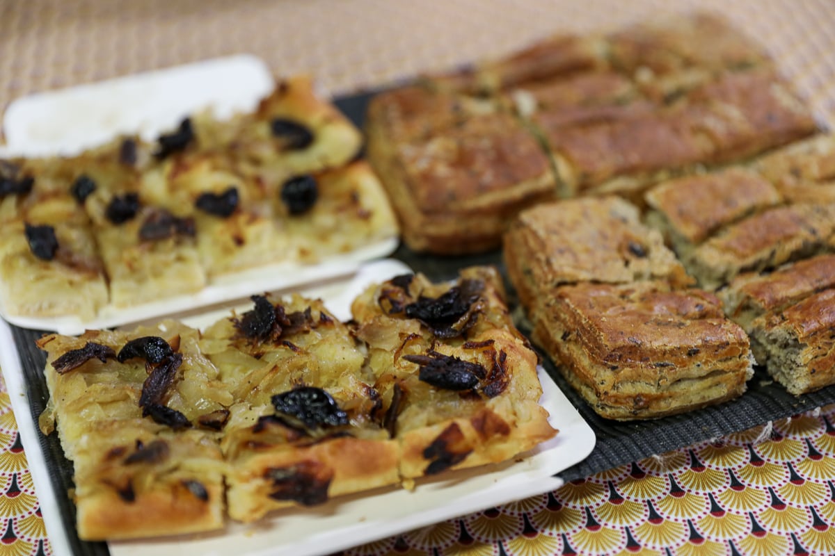 Provençal pissaladière and fougasse served during a food tour in Avignon