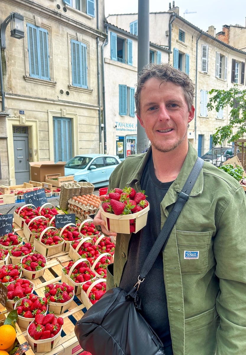 Cacey holding fresh strawberries at the Saturday Provençal market in Avignon