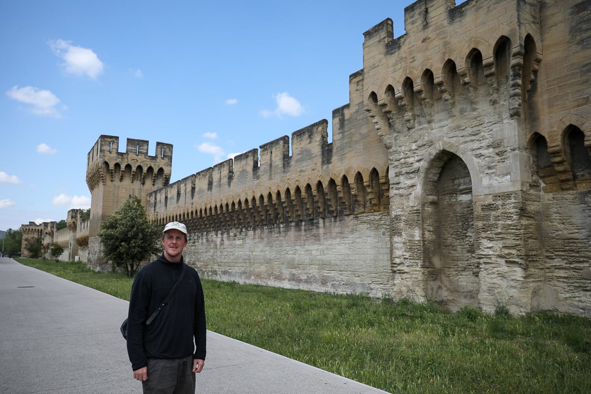 Cacey walking beside the medieval ramparts in France