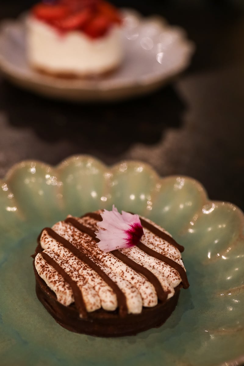 Chocolate dessert with cream and an edible flower at Café Roma in Avignon
