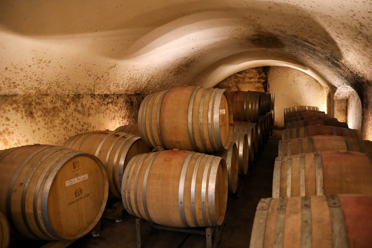 Wine barrels aging in the cellar at Château de la Font du Loup in Châteauneuf-du-Pape