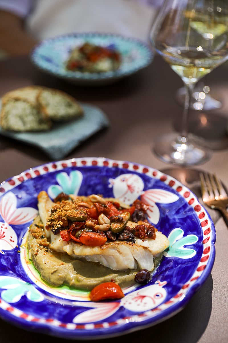 Local fish with eggplant purée, tomatoes, olives, and white wine at Italie là-bas