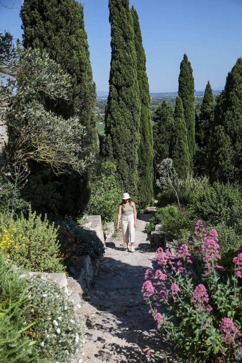 Traveler walking through the terraced gardens of Abbaye Saint-André in Villeneuve-lès-Avignon