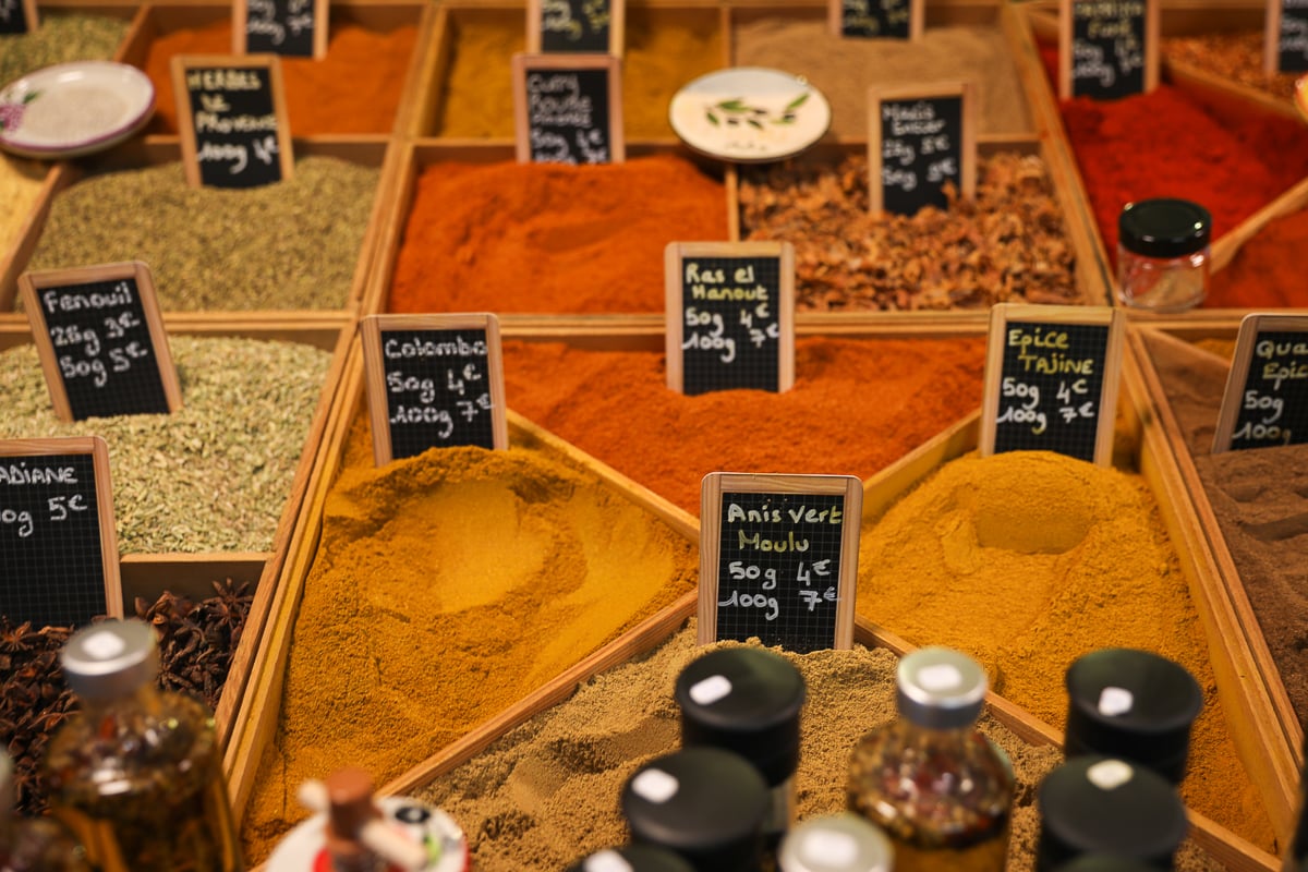 Colorful spices for sale at a stall inside Les Halles d’Avignon