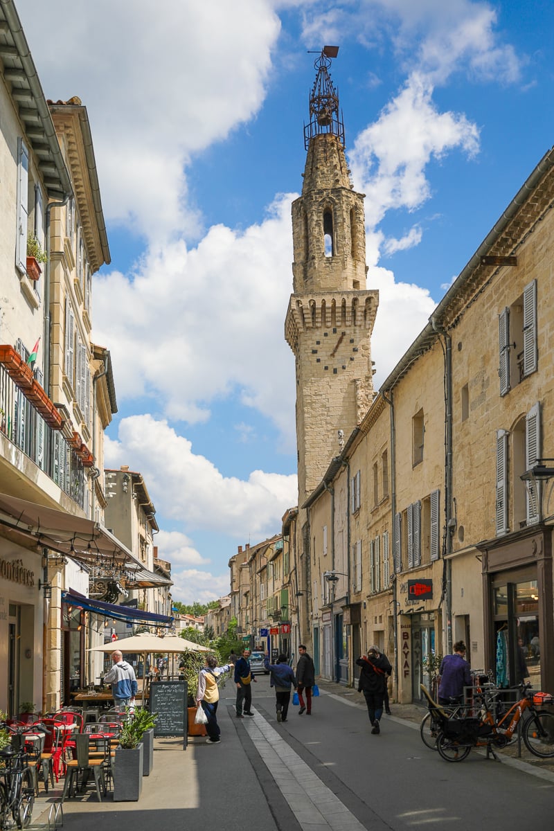Quiet street lined with shuttered historic buildings in the center of Avignon, France